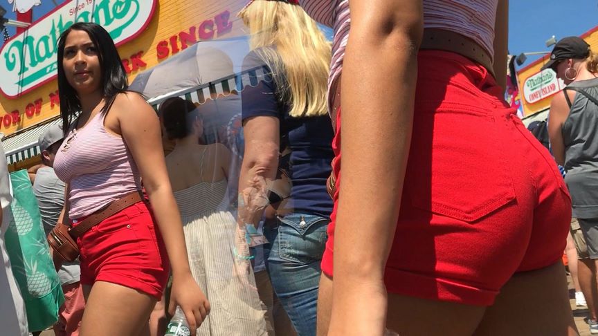 Bouncy and braless Latina with bright red wedgie shorts